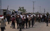 Palestinians carry bags containing food and humanitarian aid packages delivered by the Gaza Humanitarian Foundation, in Rafah, southern Gaza, June 9, 2025. (AP/Abdel Kareem Hana)