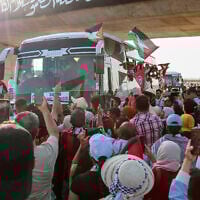 People cheer as a convoy of buses from North Africa depart from Tunisia to Gaza to break Israel's blockade on the Hamas-ruled territory, in Gabes, Tunisia, June 9, 2025. (AP)