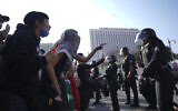 Protesters confront Los Angeles police department personnel in riot gear in downtown Los Angeles, June 9, 2025. (AP/Eric Thayer)