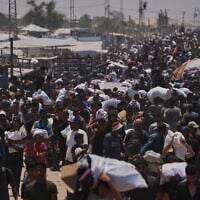 Palestinians carry bags containing food and humanitarian aid packages delivered by the Gaza Humanitarian Foundation, in Rafah, southern Gaza Strip, June 10, 2025. (AP Photo/Abdel Kareem Hana)