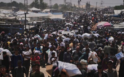 Palestinians carry bags containing food and humanitarian aid packages delivered by the Gaza Humanitarian Foundation, in Rafah, southern Gaza Strip, June 10, 2025. (AP Photo/Abdel Kareem Hana)