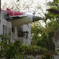 The tail of the airplane is seen stuck in a building at the site of an airplane that crashed in India's northwestern city of Ahmedabad in Gujarat state, June 12, 2025. (AP/Ajit Solanki)