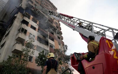 Firefighters work at the scene of an explosion at a residence compound in northern Tehran the morning after Israel launched its wave of airstrikes on the country's rogue nuclear program, military commanders, scientists and others, on June 13, 2025. (AP Photo/Vahid Salemi)