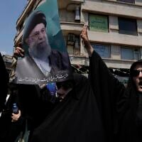 Iranian protesters chant slogans as one of them holds up a poster of the Supreme Leader Ayatollah Ali Khamenei in an anti-Israeli gathering in Tehran, Iran, Friday, June 13, 2025. (AP Photo/Vahid Salemi)