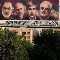 A man walks past a billboard displaying images of top Iranian commanders and scientists killed in Israeli strikes early Friday, in Tehran, Iran, Friday, June 13, 2025. (AP Photo/Vahid Salemi)
