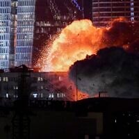 An explosion is seen during an Iranian missile attack in Tel Aviv, late on June 13, 2025. (AP Photo/Tomer Neuberg)