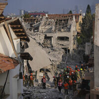Israeli security forces inspect destroyed houses that were struck by a missile fired from Iran, in Rishon Lezion, Israel on Saturday, June 14, 2025. (AP Photo/Ohad Zwigenberg)