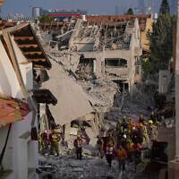 Israeli security forces inspect destroyed houses that were struck by a missile fired from Iran, in Rishon Lezion, Israel, June 14, 2025. (AP Photo/Ohad Zwigenberg)