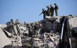 Israeli security forces inspect destroyed houses that were struck by a missile fired from Iran, in Rishon Lezion, on June 14, 2025. (AP Photo/Ohad Zwigenberg)