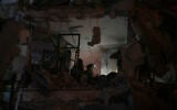 Israeli security forces inspect a destroyed building that was hit by a missile fired from Iran, in Bat Yam, early Sunday, June 15, 2025. (AP/Ohad Zwigenberg)