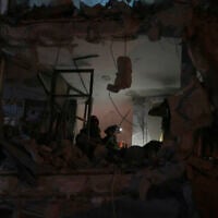 Israeli security forces inspect a destroyed building that was hit by a missile fired from Iran, in Bat Yam, early Sunday, June 15, 2025. (AP/Ohad Zwigenberg)