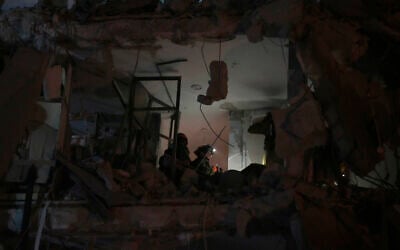 Israeli security forces inspect a destroyed building that was hit by a missile fired from Iran, in Bat Yam, early Sunday, June 15, 2025. (AP/Ohad Zwigenberg)