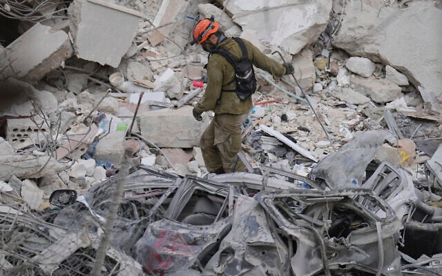An Israeli soldier navigates the rubble of a residential building that was hit by a missile fired from Iran, in Bat Yam near Tel Aviv, Israel, Sunday, June 15, 2025.(AP Photo/Ariel Schalit)