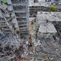 Israeli soldiers search through the rubble of residential buildings destroyed by an Iranian missile strike in Bat Yam, central Israel, June 15, 2025. (AP Photo/Baz Ratner)