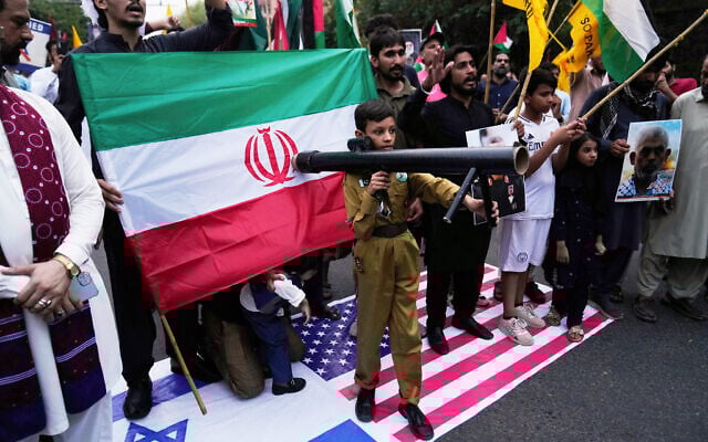 Shiite Muslims stand on depictions of the US and Israeli flags during a rally to condemn Israeli strikes on Iran in Lahore, Pakistan, Sunday, June 15, 2025. (AP Photo/K.M. Chaudary) Shiite Muslims stand on depictions of the US and Israeli flags during a rally to condemn Israeli strikes on Iran in Lahore, Pakistan, Sunday, June 15, 2025. (AP Photo/K.M. Chaudary)