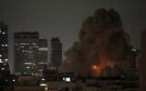 An explosion is seen during a missile attack in Tel Aviv, Israel, Sunday, June 15, 2025. (AP Photo/Leo Correa)