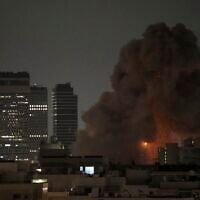 An explosion is seen during a missile attack in Tel Aviv, Israel, Sunday, June 15, 2025. (AP Photo/Leo Correa)
