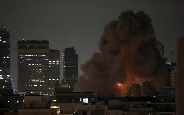 An explosion is seen during a missile attack in Tel Aviv, Israel, Sunday, June 15, 2025. (AP Photo/Leo Correa)