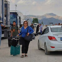 Iranians arrive to cross into Turkey at the Gurbulak Bazargan border post on the Iran-Turkey border, June 16, 2025. (AP Photo/Kadir Cesur)