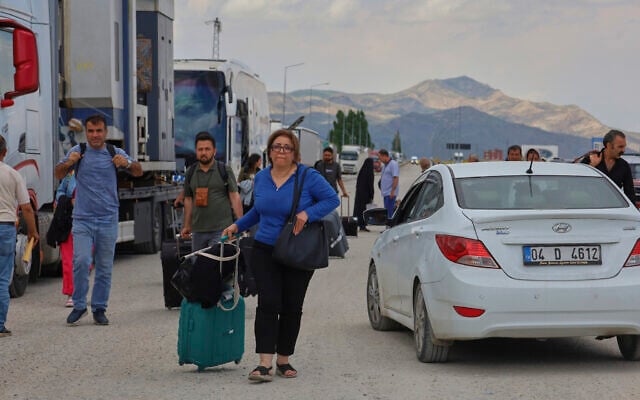 Iranians arrive to cross into Turkey at the Gurbulak Bazargan border post on the Iran-Turkey border, June 16, 2025. (AP Photo/Kadir Cesur)