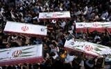 Mourners carry the flag-draped coffins of five men, whose names were not immediately available, killed in Israeli strikes, during their funeral in the city of Khorramabad, Iran, on June 16, 2025. (AP Photo/Aziz Babanezhad/Tasnim News Agency)