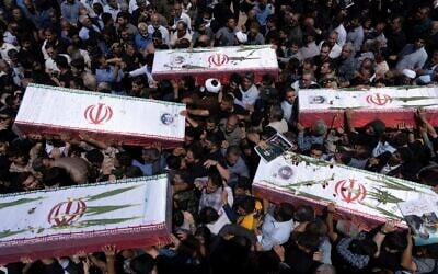 Mourners carry the flag-draped coffins of five men, whose names were not immediately available, killed in Israeli strikes, during their funeral in the city of Khorramabad, Iran, on June 16, 2025. (AP Photo/Aziz Babanezhad/Tasnim News Agency)