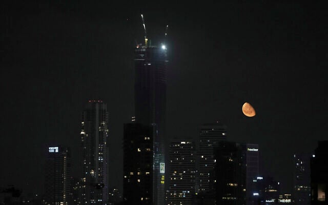 The moon rises in Tel Aviv, June 17, 2025. (AP/Leo Correa)"