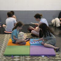 Israelis take shelter in a parking garage during a missile alert from Iran, in Tel Aviv, early June 17, 2025. (AP /Baz Ratner)