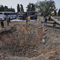 Israeli security forces inspect a site hit by a missile launched from Iran in central Israel on Tuesday, June 17, 2025. (AP/Baz Ratner)