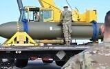 In this photo released by the US Air Force on May 2, 2023, airmen look at a GBU-57, or the Massive Ordnance Penetrator bomb, at Whiteman Air Base in Missouri. (US Air Force via AP, File)