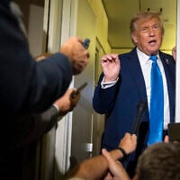 US President Donald Trump speaks with reporters while flying aboard Air Force One en route from Calgary, Canada, to Joint Base Andrews, Maryland, on June 16, 2025. (AP Photo/Mark Schiefelbein)