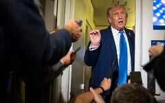 US President Donald Trump speaks with reporters while flying aboard Air Force One en route from Calgary, Canada, to Joint Base Andrews, Maryland, on June 16, 2025. (AP Photo/Mark Schiefelbein)