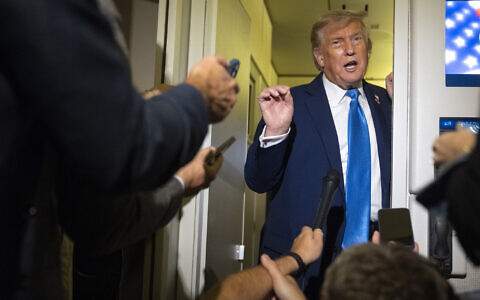 US President Donald Trump speaks with reporters while flying aboard Air Force One en route from Calgary, Canada to Joint Base Andrews, Md., late Monday, June 16, 2025. (AP/Mark Schiefelbein)