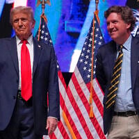 Then-Republican presidential nominee Donald Trump, left, speaks with right-wing journalist Tucker Carlson during a Tucker Carlson Live Tour show at Desert Diamond Arena, in Glendale, Arizona, October 31, 2024. (AP Photo/Julia Demaree Nikhinson)