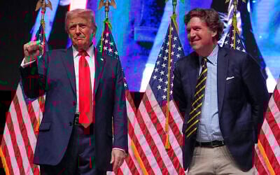 Then the Republican nominee running for a second nonconsecutive term, Donald Trump speaks with Tucker Carlson during a Tucker Carlson Live Tour show at Desert Diamond Arena, October 31, 2024, in Glendale, Arizona. (AP Photo/Julia Demaree Nikhinson)