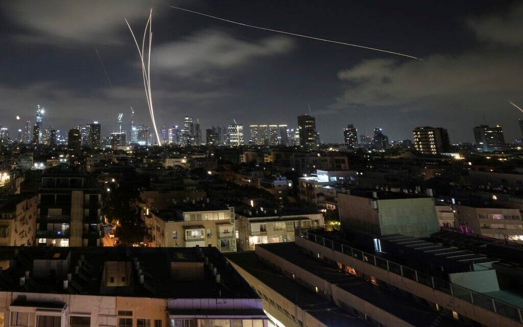 Israeli air defense systems fire to intercept missiles during an Iranian attack over Tel Aviv, early June 18, 2025. (AP Photo/Leo Correa)