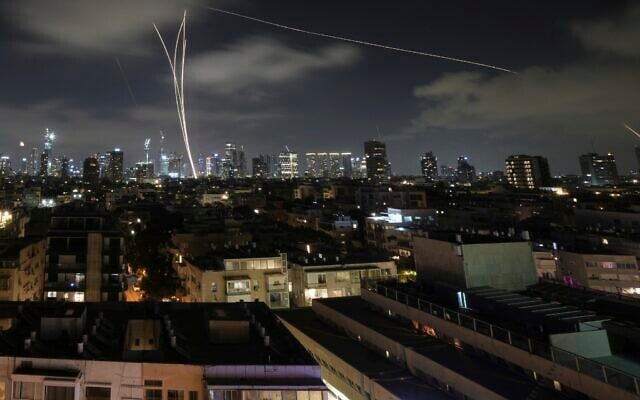 Israeli air defense systems fire to intercept missiles during an Iranian attack over Tel Aviv, early June 18, 2025. (AP Photo/Leo Correa)