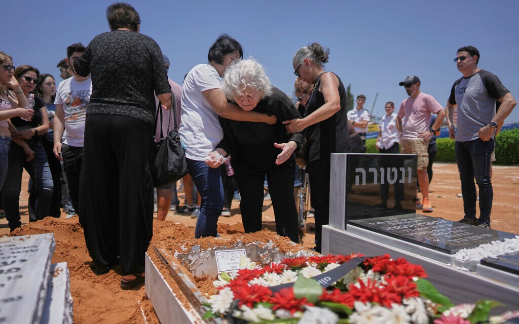 Relatives and friends of Daisy Yitzhaki, 85, who was killed during an Iranian missile attack, mourn during her funeral at Segula cemetery in Petah Tikva, June 18, 2025. (AP Photo/Oded Balilty)