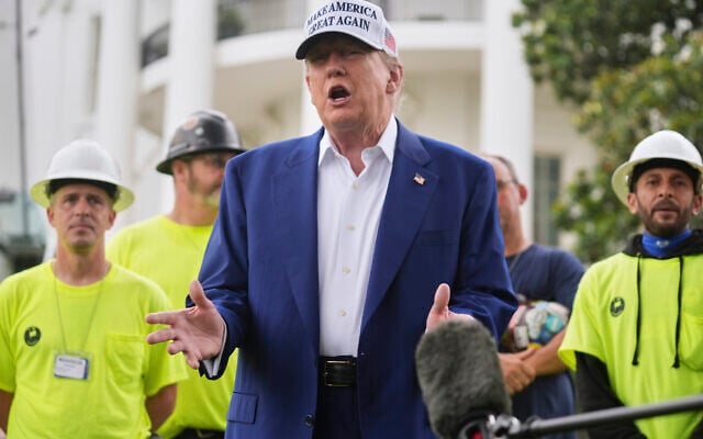US President Donald Trump speaks as a flag pole is installed on the South Lawn of the White House, Wednesday, June 18, 2025, in Washington. (AP Photo/Evan Vucci)
