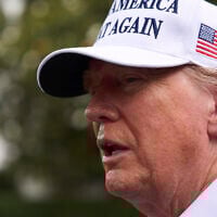 President Donald Trump speaks with reporters as a flag pole is installed on the South Lawn of the White House, June 18, 2025, in Washington. (AP Photo/Evan Vucci)