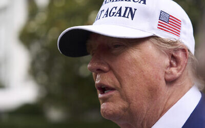 President Donald Trump speaks with reporters as a flag pole is installed on the South Lawn of the White House, June 18, 2025, in Washington. (AP Photo/Evan Vucci)