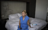 Ukrainian makeup artist Tetiana Kurakova, 40, sits in a hotel in Tel Aviv on June 17, 2025, that was turned into a shelter for evacuees from Bat Yam, which was hit by an Iranian strike. (AP/Leo Correa)