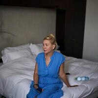 Ukrainian makeup artist Tetiana Kurakova, 40, sits in a hotel in Tel Aviv on June 17, 2025, that was turned into a shelter for evacuees from Bat Yam, which was hit by an Iranian strike. (AP/Leo Correa)