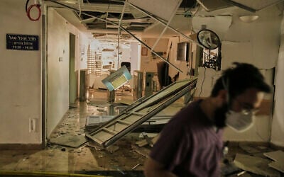 A medical staffer walks along a damaged area at the Soroka hospital complex after it was hit by a missile fired from Iran in Beersheba, Israel, Thursday, June 19, 2025. (AP Photo/Leo Correa)