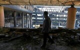 A man walks in the damaged headquarters of Islamic Republic of Iran Broadcasting, Iranian state television, in Tehran, Iran, Thursday, June 19, 2025. (AP Photo/Vahid Salemi)