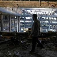 A man walks in the damaged headquarters of Islamic Republic of Iran Broadcasting, Iranian state television, in Tehran, Iran, Thursday, June 19, 2025. (AP Photo/Vahid Salemi)