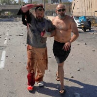 An injured man is evacuated from a site sturk by an Iranian missile in Haifa, Israel, June 20, 2025. (AP Photo/Baz Ratner)