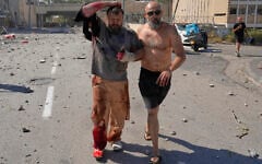 An injured man is evacuated from a site struck by an Iranian missile in Haifa, Israel, June 20, 2025. (AP Photo/Baz Ratner)