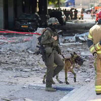 Israeli security forces and firefighters work at the site after a missile launched from Iran struck in Haifa, Israel, June 20, 2025. (AP Photo/Baz Ratner)