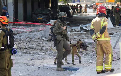 Israeli security forces and firefighters work at the site after a missile launched from Iran struck in Haifa, Israel, June 20, 2025. (AP Photo/Baz Ratner)
